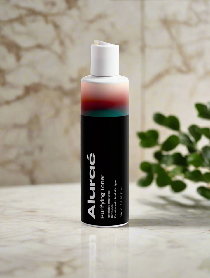 Aluráe Purifying Toner bottle on a marble countertop surrounded by greenery.